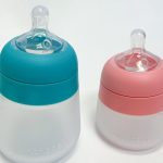 Zwei Babyflaschen aus Silikon auf hellem Untergrund